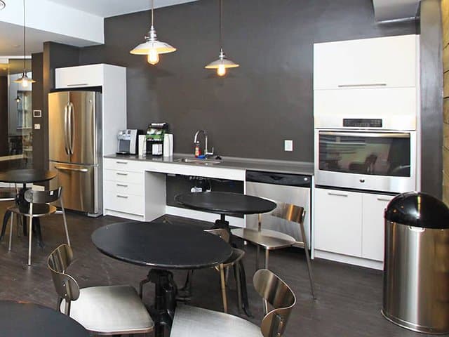 a modern white community kitchen at Ames Shovel Works in North Easton, MA