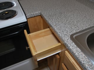 close up of a wooden drawer in a base cabinet with a laminate countertop in a Northgate apartmnet home in Revere, MA
